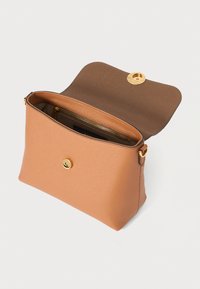 Tan leather handbag with a smooth texture and a gold snap closure. Interior features a dark brown lining and a zippered pocket.