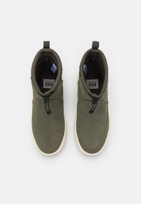 Green suede ankle boots with a smooth texture, featuring a toggle closure and white rubber soles. Two pull tabs on the top for easy wear.