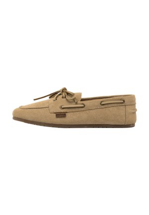 Light brown suede loafer with side lacing details, rounded toe, flat sole, and a small leather brand tag on the outer side.