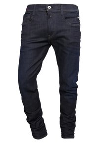 Tmavě indigo džínové kalhoty s pěti kapsami, zapínáním na knoflíky a vyšitými detaily. Slim fit s hladkým, mírně texturovaným povrchem.