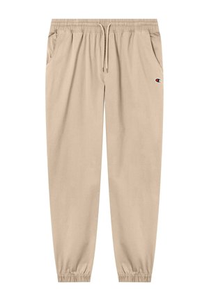 Pantalones jogger beige con cintura elástica, cordón, bolsillos laterales, puños elásticos y pequeño logo de Champion en el muslo derecho.