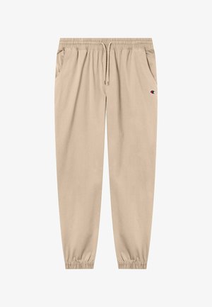 Pantalones jogger beige con cintura elástica, cordón, bolsillos laterales, puños elásticos y pequeño logo de Champion en el muslo derecho.