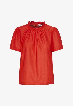 Punainen lyhythihainen pusero, jossa on röyhelökaulus ja teksturoitu kangas, jossa on geometrinen kuvio. Tavallinen istuvuus ja hieman puffattuja hihoja.