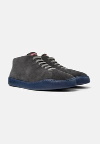 Grey suede high-top shoes with a blue rubber sole and grey laces, featuring a logo tag on the tongue.