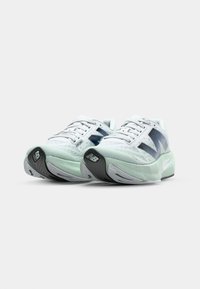 Light gray running shoes with a mesh upper, mint green accents, and a thick, cushioned sole. Features dark gray rubber outsole.