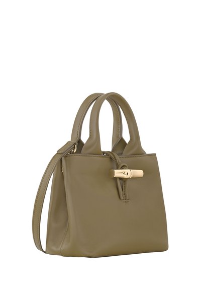 Olive green leather handbag with two top handles, a detachable shoulder strap, and a gold-tone clasp detail. Smooth texture, compact shape.