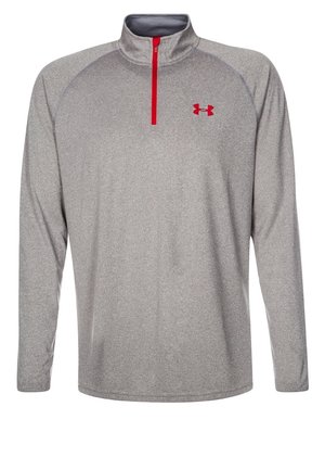 Szara sportowa bluza z długim rękawem, z czerwonym suwakiem na ćwierć długości i czerwonym logo Under Armour na lewej piersi.