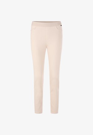 Beige pants with a smooth, stretchy fabric, featuring a tapered leg, elastic waistband, and side pockets. No visible patterns or hardware.