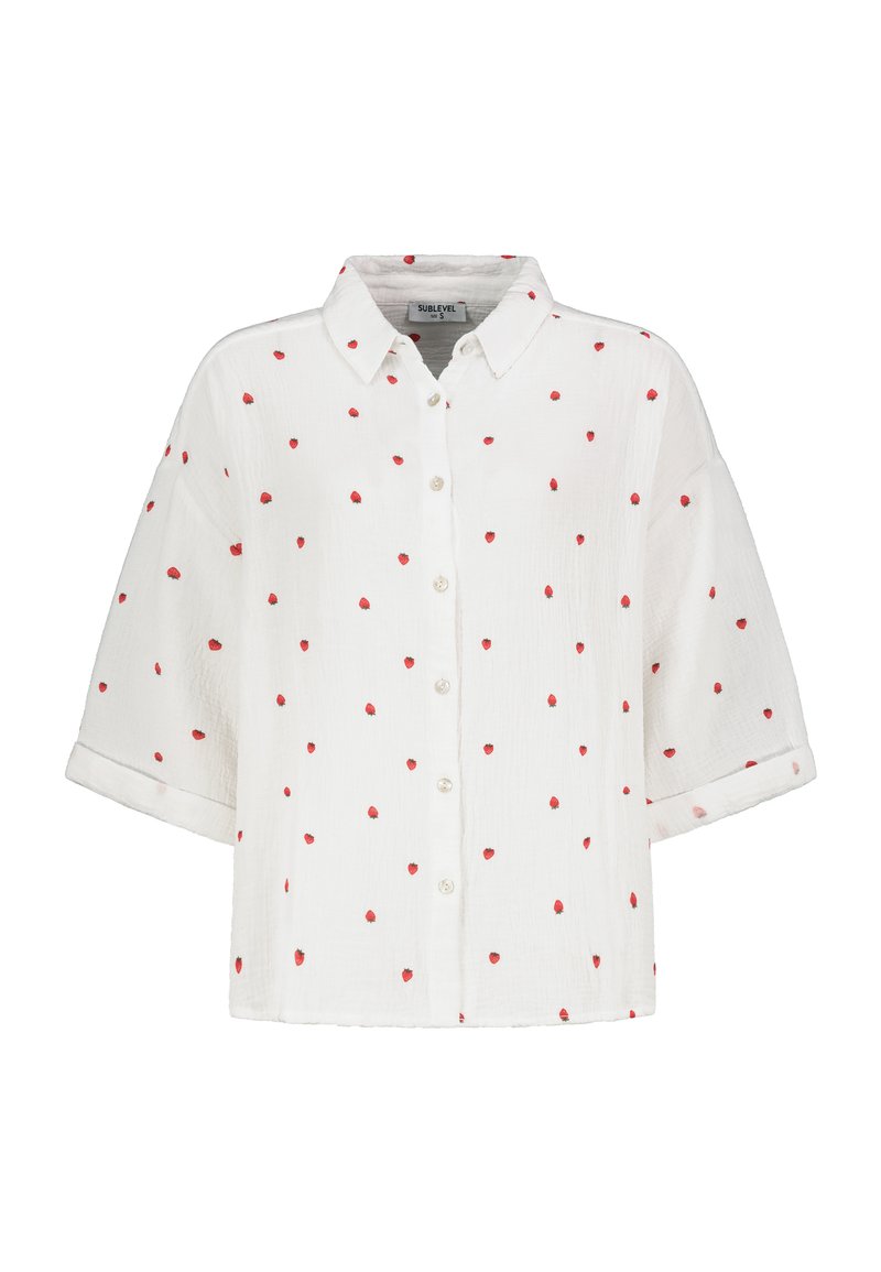 White button-up shirt with short sleeves, featuring a textured fabric and red heart patterns scattered across the surface.