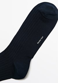 Calzini a costine blu navy realizzati in un tessuto liscio; presentano un'area rinforzata sulla punta e l'etichetta stampata "Massimo Dutti" sul lato.
