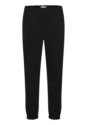Sorte joggebukser laget av mykt stoff, med elastisk midjebånd med snor, sidelommer og innsnevrede mansjetter ved anklene.