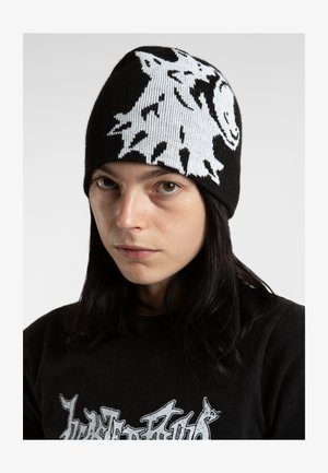 Black knitted beanie featuring a white graphic design of a wolf's head. Close-fitting with a smooth texture.