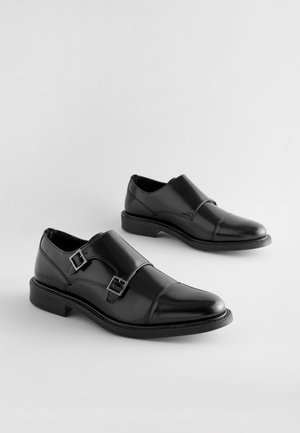 Pantofi negri din piele, cu două catarame ajustabile, finisaj neted, vârf rotunjit și toc scăzut cu strat stratificat.