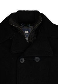 Abrigo de lana negro con cuello alto, botones de doble pecho y un forro interior con cremallera que presenta un patrón en azul y negro.