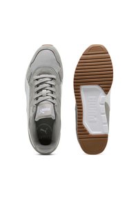 Grey athletic sneakers with a suede and mesh upper, lace-up closure, and rubber outsole featuring a prominent logo and ridged pattern.