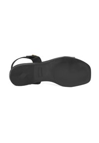 Black sandal with a textured upper, open toe, and adjustable slingback strap. The sole is flat with a patterned tread for grip.