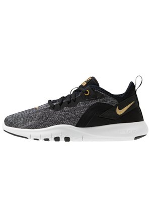 Czarno-szary but do biegania Nike Flex z białą podeszwą i złotym logo Swoosh, oddychającą cholewką z tkaniny i pętelką na pięcie.
