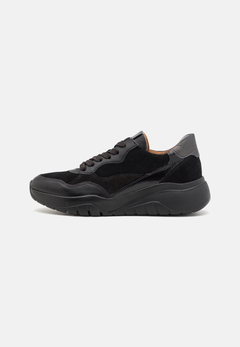Black sneakers featuring a mix of suede and leather, rounded toe, thick textured sole, and lace-up front. Subtle design accents in grey.