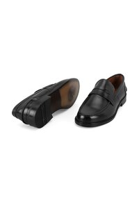 Zwarte leren loafers met een ronde neus, decoratieve band en contrasterende stiksels. Soepele textuur en een duurzame rubberen zool.