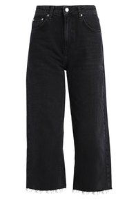 Svarta denimbyxor med vida ben och hög midja, med framfickor och rå nederkant. Tyget har en mjuk textur och minimal töjning.