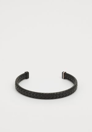 Black braided leather cuff bracelet with rectangular ends and smooth texture. Features subtle metallic accents embedded in the design.