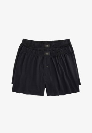 Zwarte katoenen boxershorts met een elastische tailleband en knoopsluiting, weergegeven in een gestapelde opstelling.