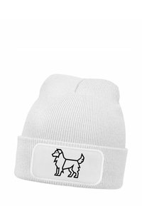 Knit white beanie with a folded cuff, featuring a black line art dog design on a white patch. Textured fabric with a ribbed pattern.