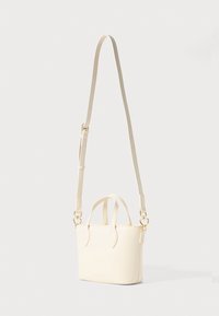 Cream leather handbag with two short handles and a detachable long strap. Features gold-tone hardware and a smooth, minimalist design.