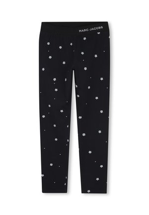 Leggings noirs avec petits motifs de fleurs blanches et logo "Marc Jacobs" sur le devant droit de la ceinture.