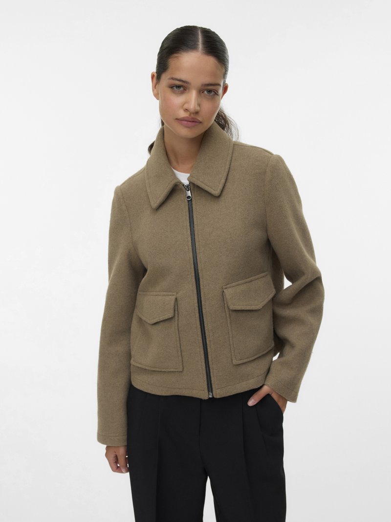 Brown wool-blend jacket with a collared neckline, front zip closure, and two large patch pockets. Tailored fit and smooth texture.