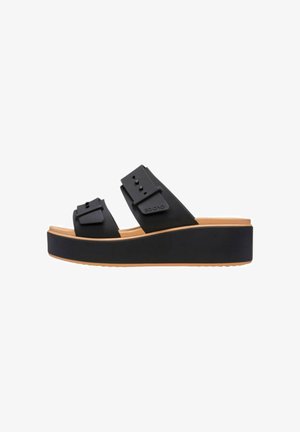 Sandalo platform nero con due cinturini regolabili e suola color cuoio, visto di lato su sfondo bianco.