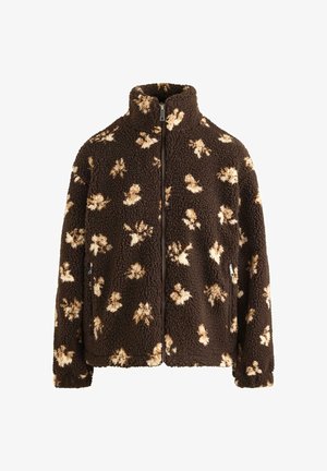 Bruine fleecejas met crèmekleurige bloemenpatronen, hoge kraag en ritssluiting aan de voorkant. Voorzien van zijzakken en een gestructureerd oppervlak.