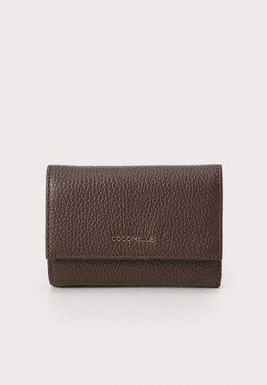 Brown leather wallet with a pebbled texture, featuring a gold logo on the front, and a compact, rectangular shape.