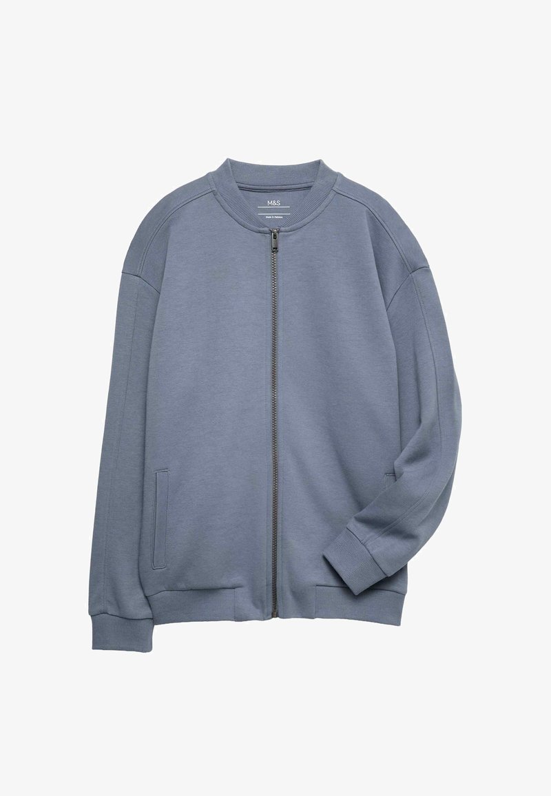 Sudadera gris con cremallera, con cuello redondo, mangas largas, bolsillos laterales, puños y dobladillo acanalados, hecha de un tejido suave y texturizado.