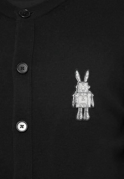 Black buttoned cardigan with a small silver embroidered patch showing a robot with bunny ears on the chest.