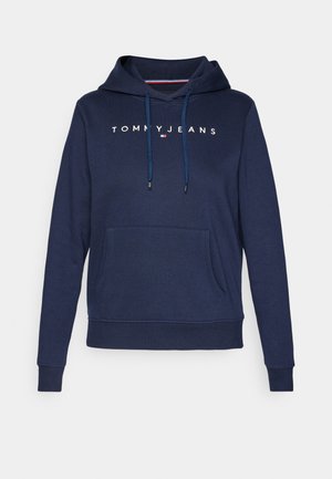 Marineblauwe hoodie met een voorzak, met de tekst "TOMMY JEANS" in het wit. Inclusief trekkoorden met blauwe accenten en geribbelde manchetten.