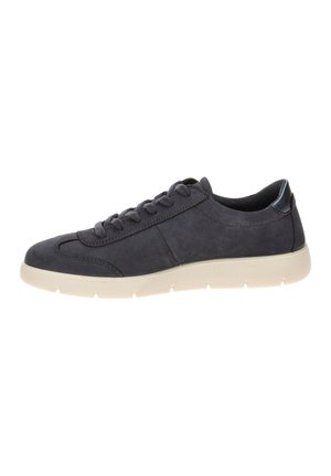Black low-top sneaker with black laces and padded collar, featuring a thick white rubber sole and suede-like texture.