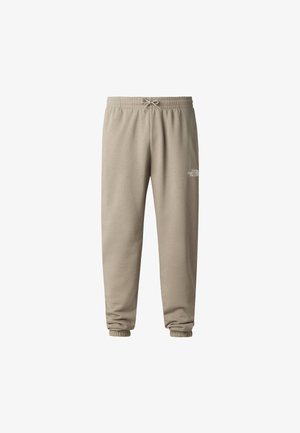 Hellbeige Sweatpants aus weichem Stoff, mit elastischem Bund und Kordelzug sowie Bündchen an den Fußgelenken. Kleines Logodetail.