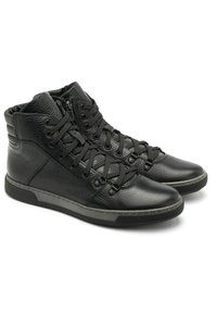 Czarne skórzane buty wysokie z teksturowanym wykończeniem, z okrągłym czubkiem, sznurowanym zapięciem i wyściełanym kołnierzem. Akcentujące przeszycia na podeszwie.