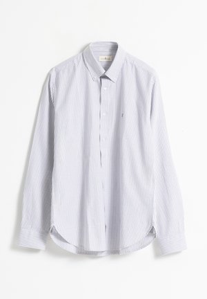 Camisa de manga larga a rayas azules y blancas con cuello tipo polo, dobladillo redondeado y un pequeño logo en el pecho. Fabricada con una tela suave.