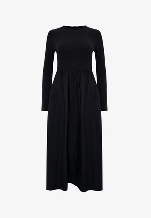 Schwarz langärmliges Kleid mit einer taillierten Oberseite und einem fließenden, gerafften Rock. Hergestellt aus weichem, strukturiertem Stoff mit einem runden Ausschnitt.