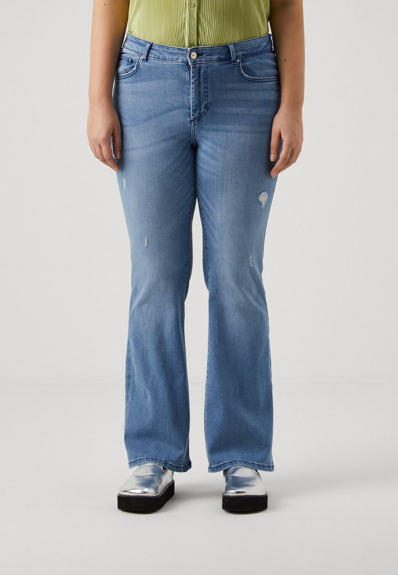 Light blue flared jeans with distressed detailing on the knees, featuring a five-pocket design and silver button closure.