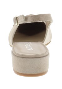 Beige suede platform sandal with a wide strap, back heel, and a buckle closure. Smooth interior and flat rubber sole.