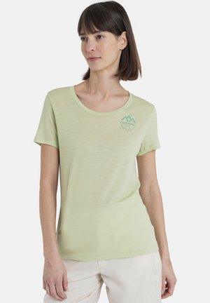 Light green short-sleeve t-shirt with a scoop neckline and a small, turquoise mountain logo on the chest. Made from soft, textured fabric.