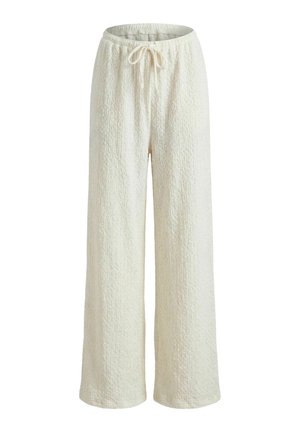Pantalon large blanc texturé et confortable avec taille élastique et cordon de serrage, adapté pour une tenue décontractée.
