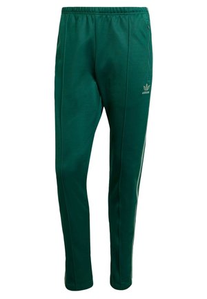 Pantalon de survêtement Adidas vert foncé avec taille élastique, poche zippée sur le côté et bandes blanches le long des jambes extérieures.