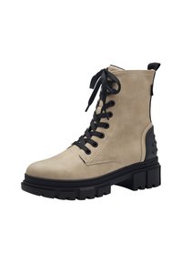 Bottes à lacets beige à la cheville avec une semelle noire épaisse, en matériau velouté lisse, et des lacets noirs. Le détail latéral présente un accent noir texturé.