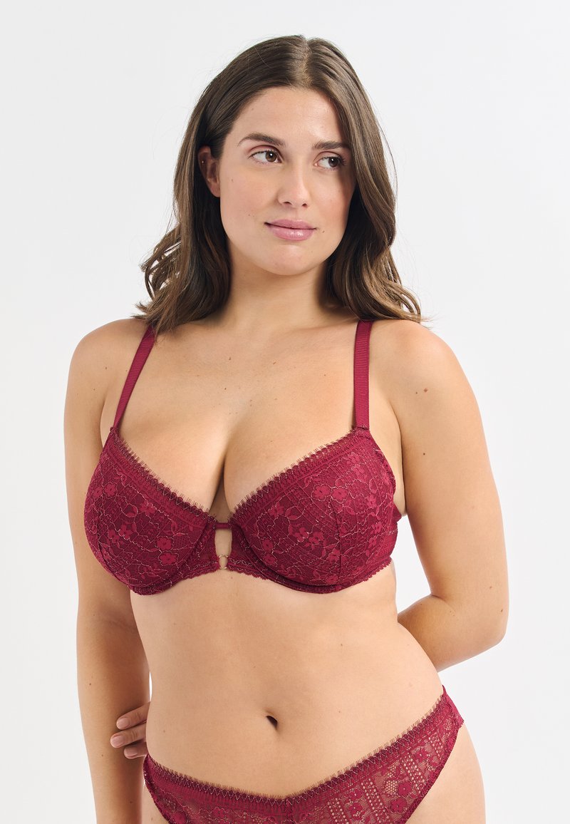 Burgunderfarbener Spitzen-BH mit tiefem Ausschnitt, verstellbaren Trägern und floralen Mustern. Enthält ein kleines Schlüsseleinlassdetail in der Mitte.