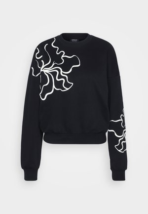 Must väärtuslik must dressipluus, millel on vasakul rinnal ja varrukal lainelised valged lillemustrid. Valmistatud pehmest kangast, millel on soonikkoes varrukate otsad.