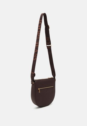 Brun crossbody taske med guld lynlåslomme og justerbar stofrem med tryk af "JOOP! JEANS" i store bogstaver.